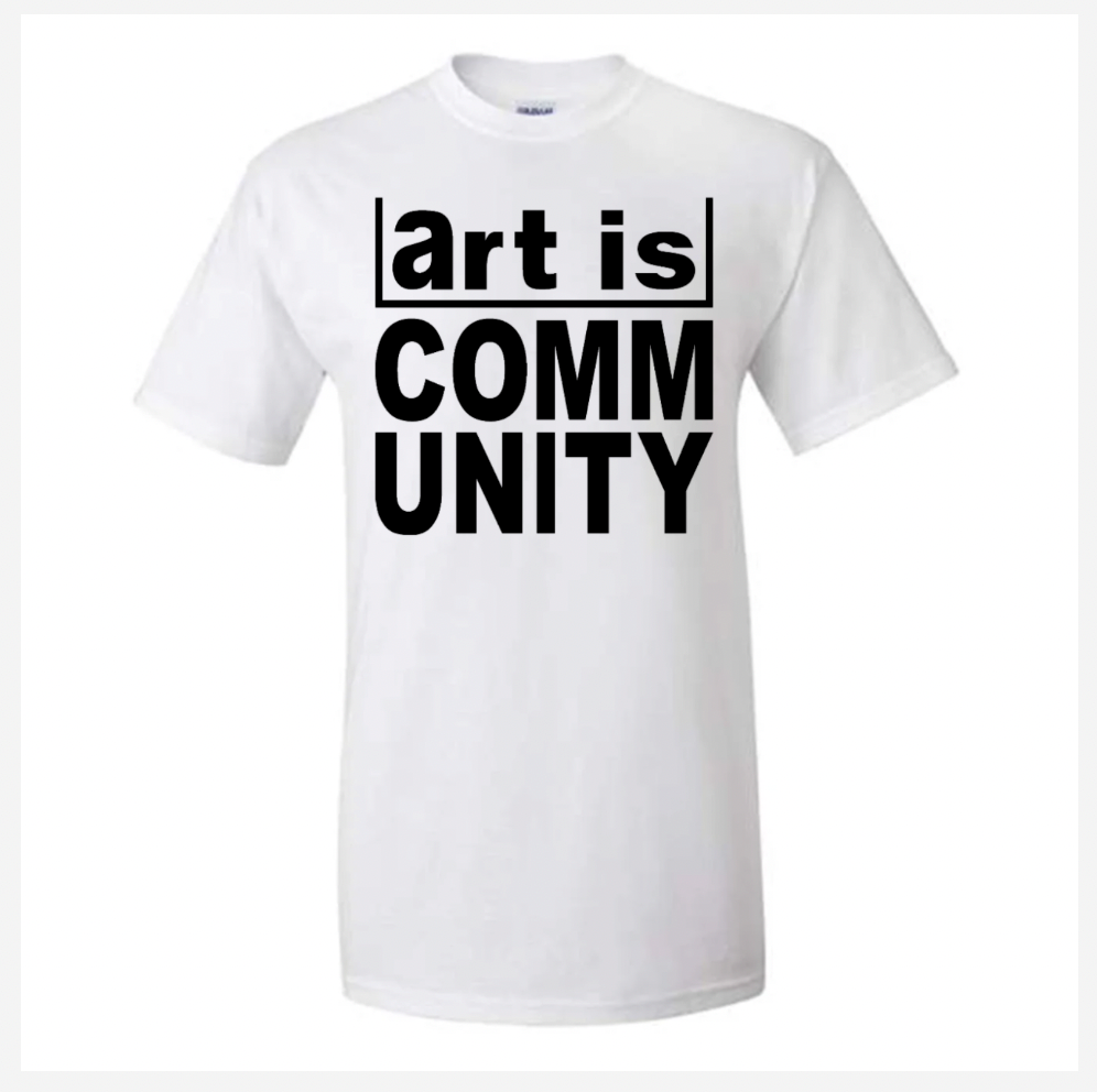 White t-shirt with 'art is COMMUNITY' text on a white background